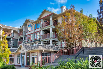Low-rise residential building with stairs on the side through the land terrace