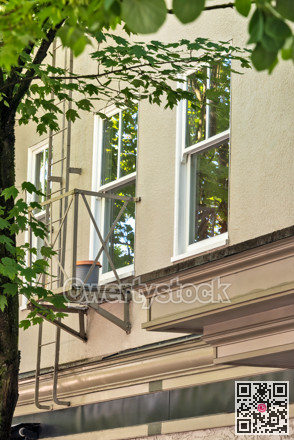 Yellow wall and windows of old residential building in North Vancouver
