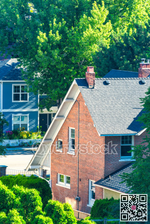 Historic residential houses among the trees on the street