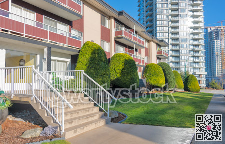 Small porch with steps to the entrance at low rise residential building