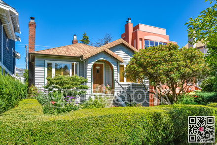 Residential house with green hedge on front yard