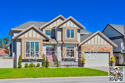 Suburban family house with green lawn in front