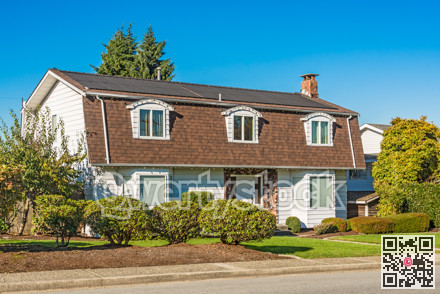 Big residential house on the street on sunny autumn day