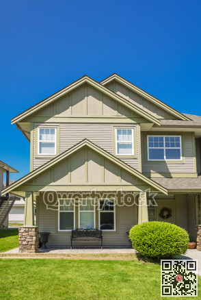 Suburban residential house with green lawn in front