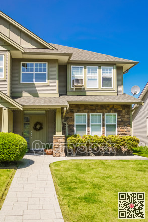 Entrance of family house with concrete pathway over green lawn