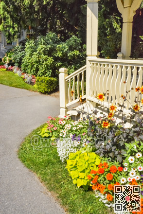 Colorful blossoming flowers in front of a church porch