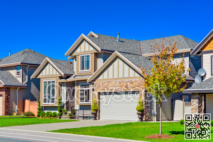 Suburban family house with green lawn in front