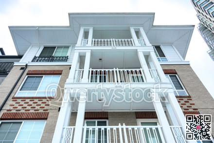 Top of residential buildings on overcast sky background