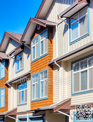 Facade of residential townhouses on a bright sunny day