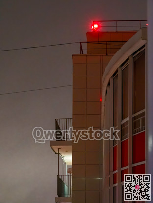 Red light signal on the top of highrise residential building