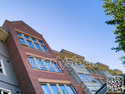 Residential building brick wall on blue sky background
