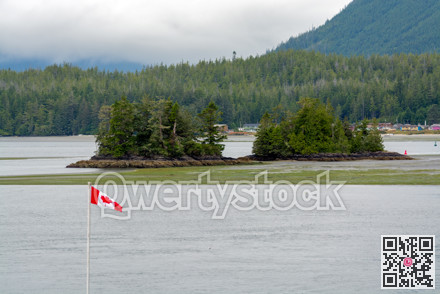 Canadian flag on Pacific ocean shore on Vancouver island