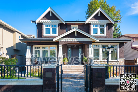 Luxury residential house with grid and stone fence in front